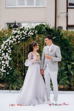 wedding ceremony of the newlyweds on the glade near the restaurant