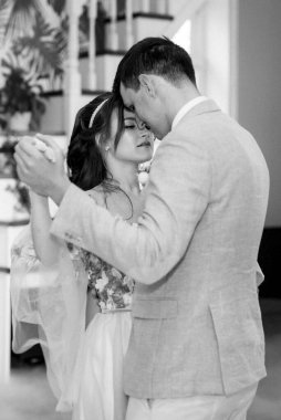 the first dance of the bride and groom inside a restaurant with heavy smoke