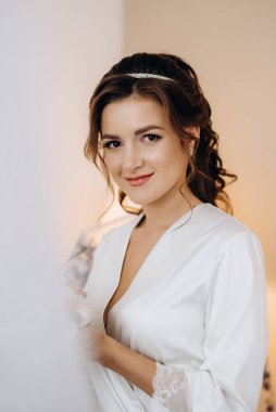 morning of the bride with the creation of the image of makeup and the creation of hairstyles