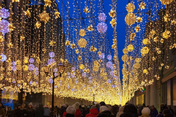 Kavramsal deffocused soyut Noel dekorasyon ve gece şehir caddesinde insanların kalabalık