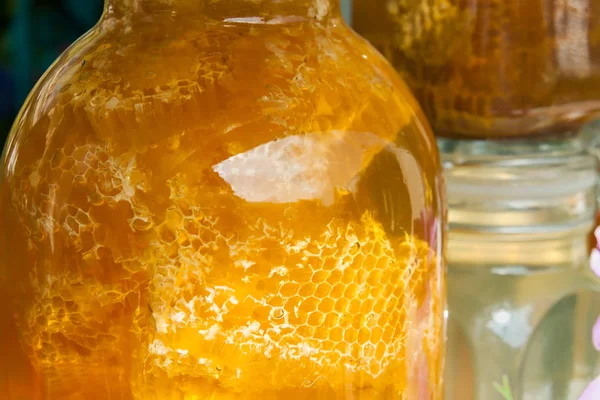 Big honey with cells of wax glass jar close-up — Stock Photo, Image
