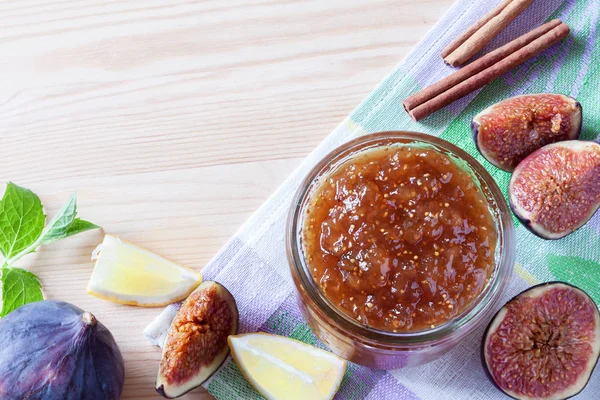 Whole and cut figs, with dish of homemade fig jam or marmalade kitchen wooden table with copy space. — Stock Photo, Image