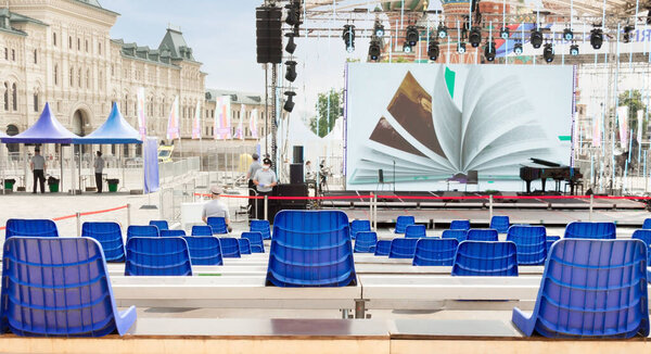 A row of plastic chairs in public place keeping space between each chair make separate to avoid spreading infection COVID-19. To stop spreading germs and viruses. Social distancing regulations concept.