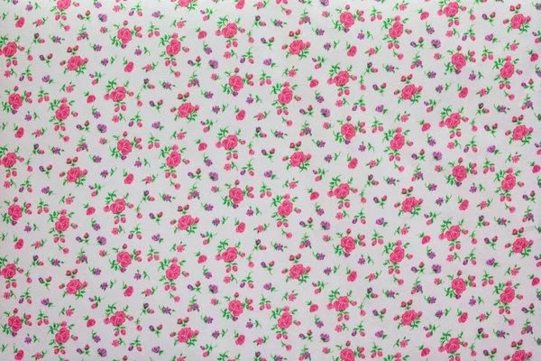 Un morceau de tissu avec l'image de petites fleurs aux couleurs pastel — Photo