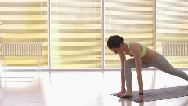 Young woman practicing yoga in studio — Stock Video
