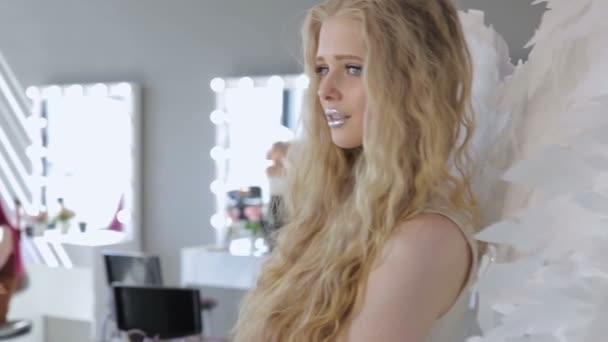 Красивая молодая блондинка позирует перед камерой — стоковое видео