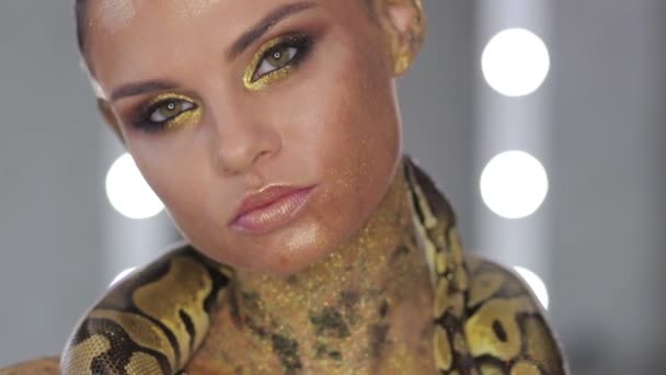 Woman with body art holding snake — Stock Video