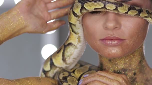 Woman with body art holding snake — Stock Video