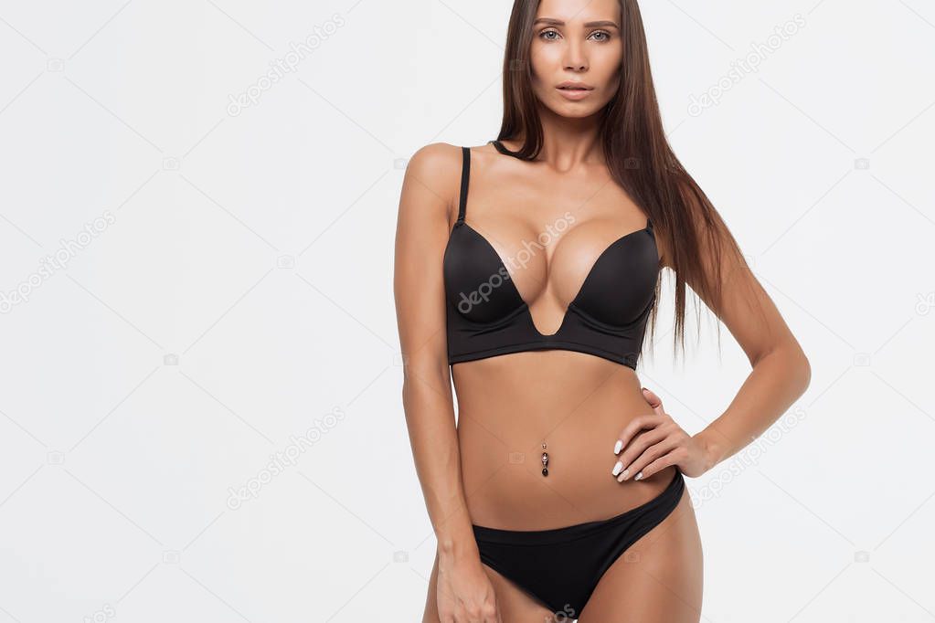 Sexy woman in a black lingerie on the white background