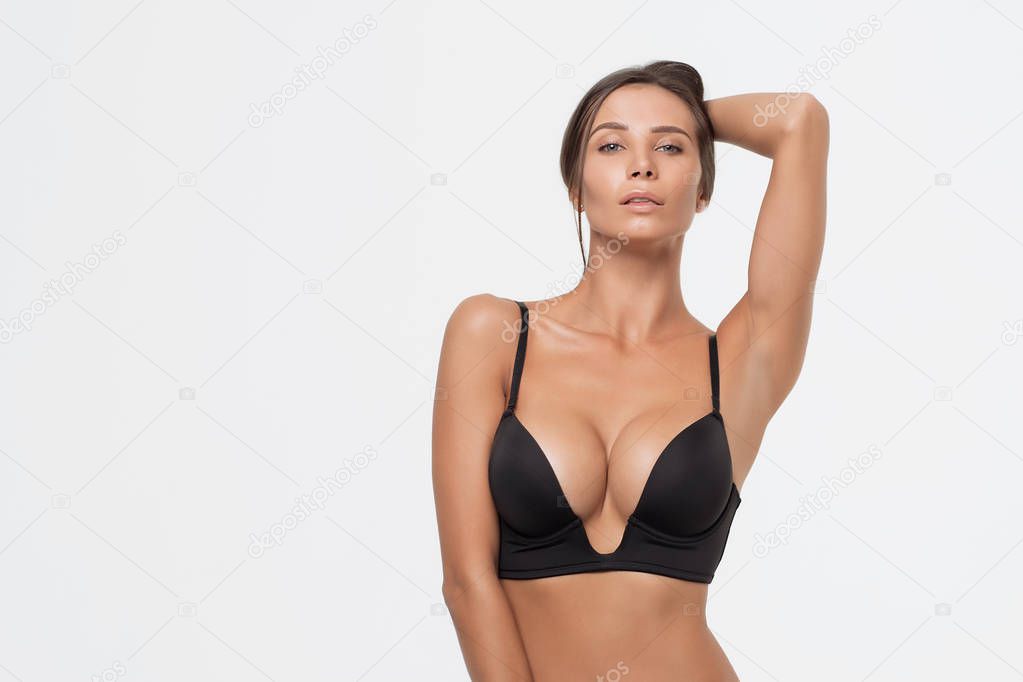 Sexy woman in a black lingerie on the white background