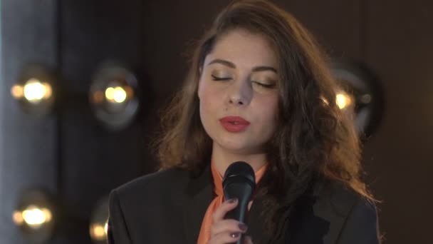 Bella giovane donna che canta al microfono — Video Stock