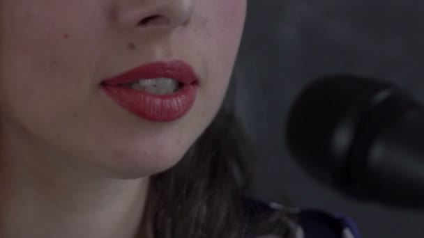 Närbild bilder av en kvinna som sjunger till en mikrofon — Stockvideo