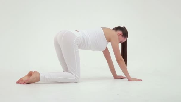Menina fazendo exercício com maça na mão no estúdio no fundo branco, câmera lenta — Vídeo de Stock