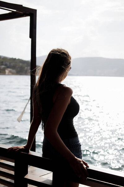 Sensual woman in wet swimwear near pool