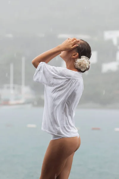 Sensual woman on rainy day