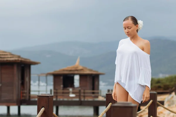 Woman in white blouse on resort