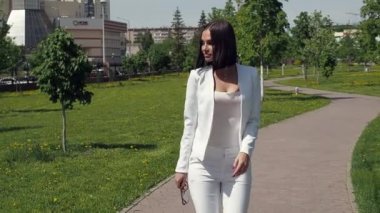 Parkta yürüyen şık bir kadın.