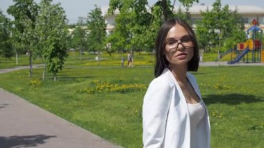 Parkta yürüyen şık bir kadın.