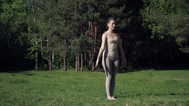 Vrouw doet yoga in het park — Stockvideo