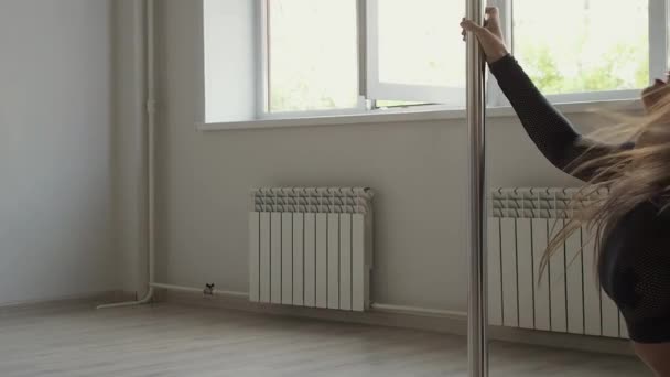 Flexibel kvinna dansar på stolpe i studio — Stockvideo