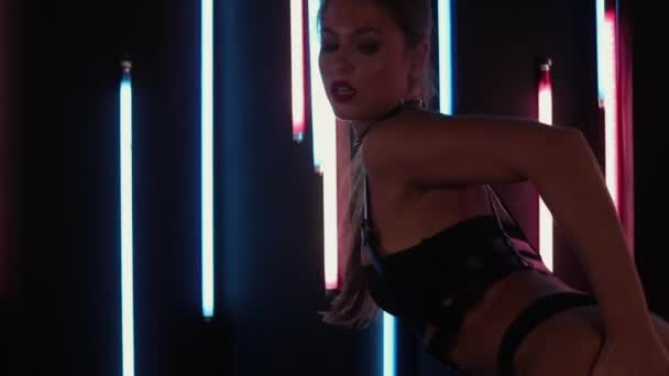 Female stripper dancing in neon lights — Stock Video
