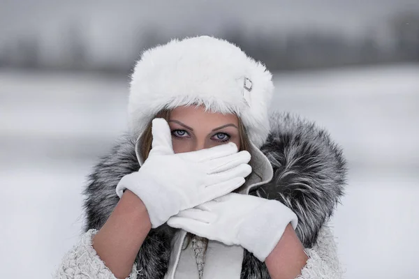 Winter merry mood, of girl with wonderful blue eyes .