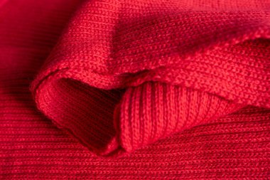 The texture of the red knitted fabric close up