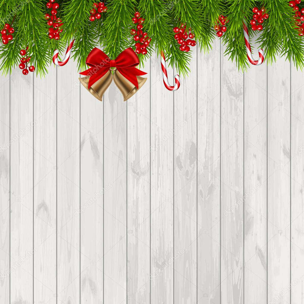 Christmas background with fir branches and red berries, isolated on wood background.