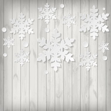 Ahşap arka plan üzerinde kağıt kar taneleri ile Noel tebrik kartı.