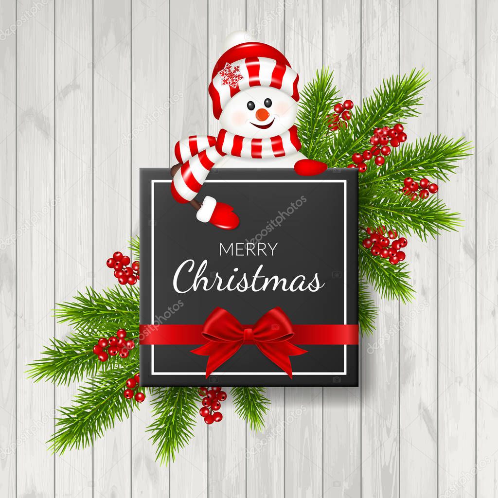 Christmas background with fir branches and red berries, isolated on wood background.