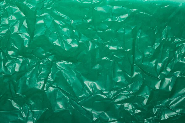 Pomarszczony zielony plastik dla tła lub tekstu — Zdjęcie stockowe