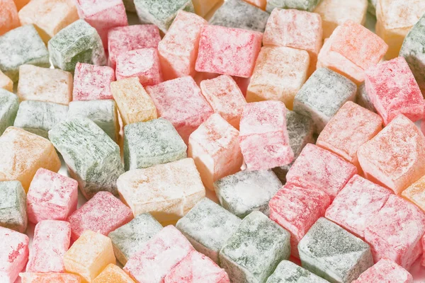 Pieces of multicolored Turkish Delight in powdered sugar. — Stock Photo, Image