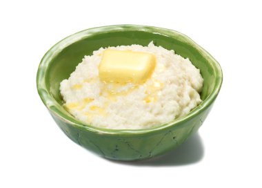Pirinç lapası yeşil bir kapta tereyağı ile kahvaltıda.