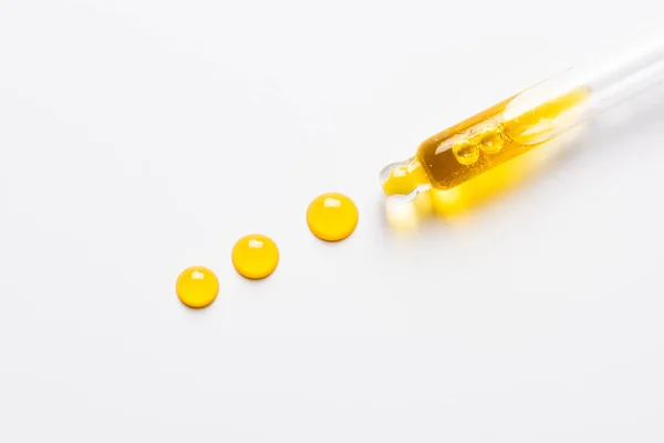 Sarı yağlı kozmetik damlası. Beyaz üzerine yaşlanma önleyici serum.