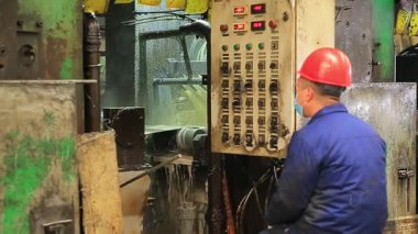 Çelik fabrikası atölyesinde mekanik ekipmanlar çalışıyor.