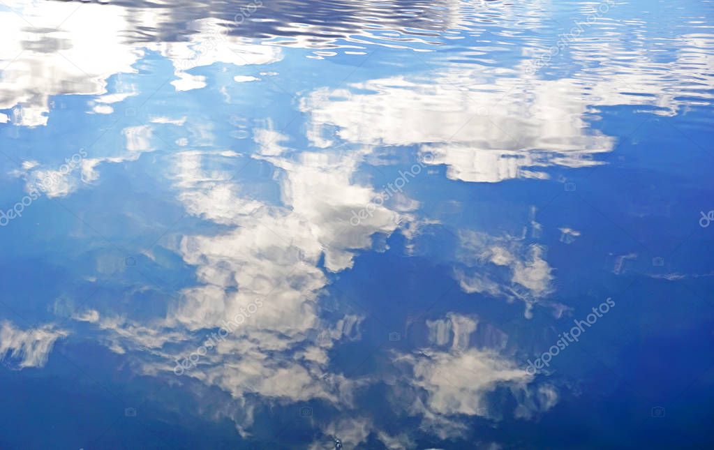 clouds are reflected in the water