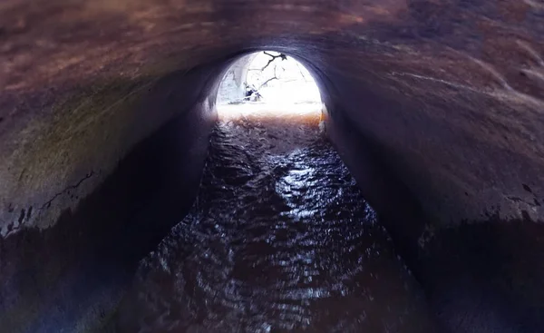 Water drainage channel. Light at End of Round Tunnel.