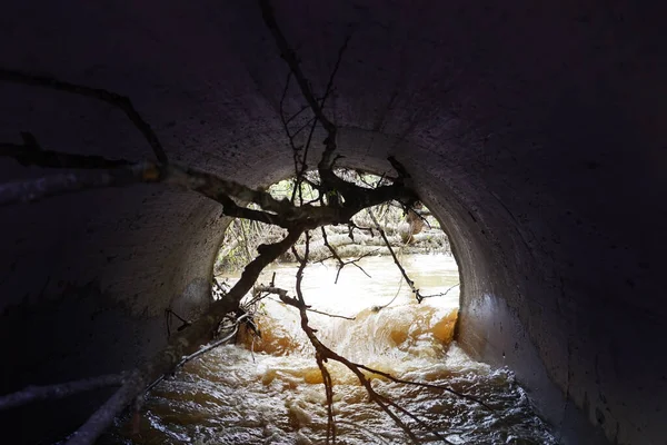 Water drainage channel. Light at End of Round Tunnel.