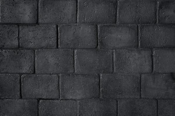 Tuğla siyah duvar. Eski bir tuğla evin arka planı.                               