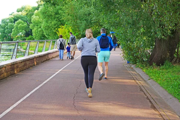 Group of active people running in the park. Healthy lifestyle. Weight Loss.