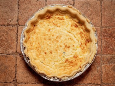Bir kiremit yüzeyinde Quiche lorraine üst görünümü. Fransız usulü pasta yemekleri.