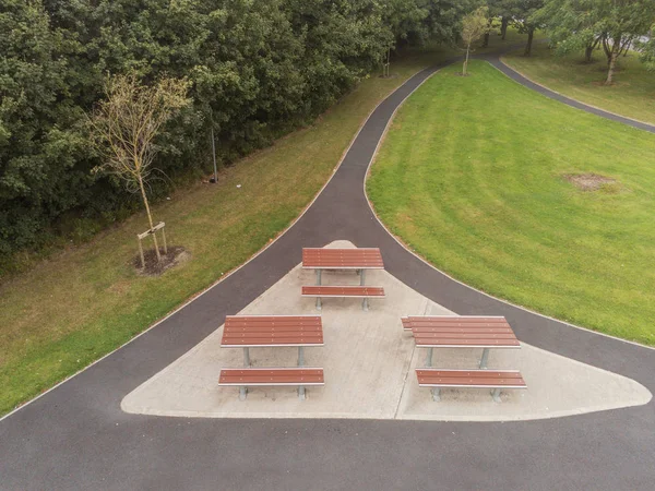 Aerial view, Small picnic area in a park, Metal and plastic materials used to make table and chair. Wheel chair accessible.