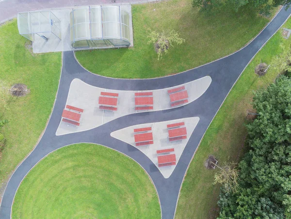 Aerial view .Picnic area in a park, with smoking area, Metal tables with red plastic surface. Modern design.