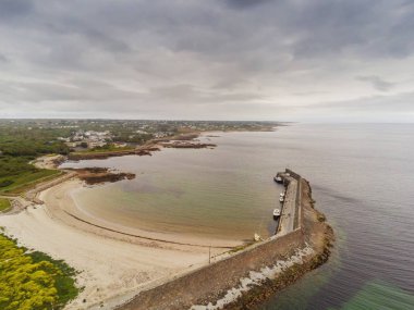 Pier and beach in Spiddal town, county Galway, Ireland. Aerial view, Cloudy sky. Landscape. clipart