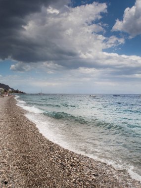 Summer holiday background, Sicily coast, Clear blue wave of the Mediterranean sea, Selective focus. Vertical image.