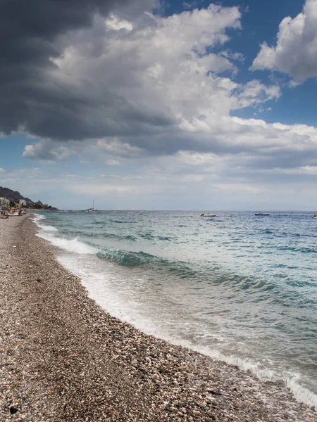 Summer holiday background, Sicily coast, Clear blue wave of the Mediterranean sea, Selective focus. Vertical image.