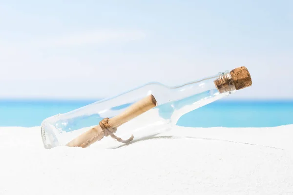 Message in bottle on beach with white sand,  in tropical se