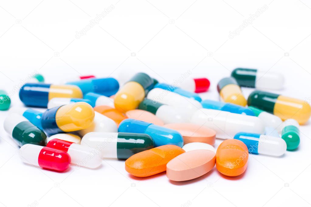 Pharmaceutical medicament, with colored pills and capsule on white background. Drug prescription for treatment medication