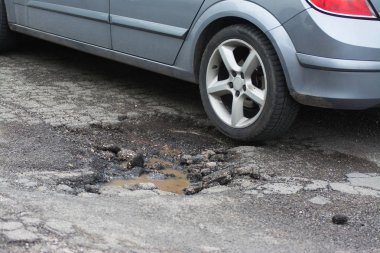 Big pothole caused by freezing and rain in Rome, Italy clipart