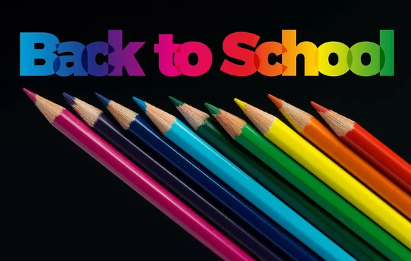 Back to school. Color pencils isolated on black. Text — Stock Photo, Image